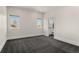 A light-filled bedroom with two windows and neutral-toned carpet flooring at 5240 N Raleigh St, Denver, CO 80212
