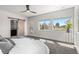A bright bedroom with a barn door leading to the bathroom and a door to access the balcony at 5240 N Raleigh St, Denver, CO 80212