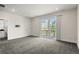 Large bedroom with a sliding door to a balcony, neutral walls, and carpeted floors, creating a serene retreat at 5240 N Raleigh St, Denver, CO 80212