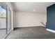 Spacious carpeted bonus room with a sliding glass door that opens to a private balcony at 5240 N Raleigh St, Denver, CO 80212
