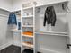 Organized walk-in closet with built-in shelves and hanging rods for optimal storage of clothes and accessories at 5240 N Raleigh St, Denver, CO 80212