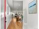 Modern foyer with hardwood floors and an open floorplan featuring a view of the living and dining areas at 5240 N Raleigh St, Denver, CO 80212