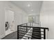 Hallway with stairs, and a laundry room showcasing convenient access to amenities at 5240 N Raleigh St, Denver, CO 80212