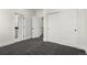 Hallway with large sliding closet door, access to the bathroom and stairs with nice carpet at 5240 N Raleigh St, Denver, CO 80212