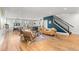 Spacious living room with hardwood floors and open concept connecting to dining area, kitchen, and staircase at 5240 N Raleigh St, Denver, CO 80212