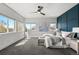 Sun-filled main bedroom featuring a ceiling fan, neutral color palette, carpet, and views from multiple windows at 5240 N Raleigh St, Denver, CO 80212