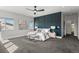 Bright main bedroom with stylish gray carpet, decorative accent wall, ceiling fan, and a pair of benches at 5240 N Raleigh St, Denver, CO 80212