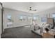 Bright main bedroom featuring modern ceiling fan, multiple windows with nice views, and light-colored walls at 5240 N Raleigh St, Denver, CO 80212