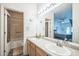 Bright bathroom features a double vanity with ample countertop space and a separate toilet and shower area at 7080 Simms St # 105, Arvada, CO 80004
