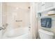 Clean and functional bathroom with a white tiled shower/tub combination and grab bars for accessibility at 7080 Simms St # 105, Arvada, CO 80004