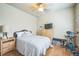 Well-lit bedroom with wood flooring, ceiling fan, and ample space at 7080 Simms St # 105, Arvada, CO 80004