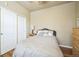 Comfortable bedroom featuring wood floors, a closet, and soft lighting at 7080 Simms St # 105, Arvada, CO 80004