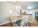 Dining area with stylish table and seating adjacent to the kitchen at 7080 Simms St # 105, Arvada, CO 80004