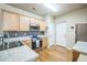 Updated kitchen features stainless appliances, wood floors, and modern finishes at 7080 Simms St # 105, Arvada, CO 80004