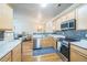 Open kitchen features stainless appliances, wood floors, and seamless flow to living spaces at 7080 Simms St # 105, Arvada, CO 80004