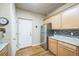 Bright kitchen features stainless appliances and light wood cabinetry at 7080 Simms St # 105, Arvada, CO 80004