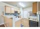 Bright kitchen features stainless appliances, wood floors, and granite countertops at 7080 Simms St # 105, Arvada, CO 80004