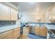 Spacious kitchen features stainless appliances, wood floors, and plenty of natural light at 7080 Simms St # 105, Arvada, CO 80004