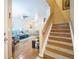Open-concept living area featuring hardwood floors, comfortable furniture, and a staircase at 7080 Simms St # 105, Arvada, CO 80004