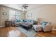 Cozy living room featuring a plush gray sofa, natural light, and stylish decor at 7080 Simms St # 105, Arvada, CO 80004