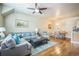 Bright and airy living area with a large sectional sofa, dining table, and seamless open-concept design at 7080 Simms St # 105, Arvada, CO 80004