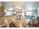 Open concept living space features dining area, kitchen, and living room at 7080 Simms St # 105, Arvada, CO 80004