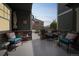Inviting covered front patio with cozy seating, providing a relaxing outdoor space with nice neighborhood views at 7080 Simms St # 105, Arvada, CO 80004