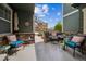 Inviting covered front patio with cozy seating, providing a relaxing outdoor space with nice neighborhood views at 7080 Simms St # 105, Arvada, CO 80004