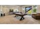 Spacious basement with a pool table, comfortable seating, and a walk-out to the backyard at 17637 W 87Th Ave, Arvada, CO 80007