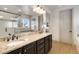 Bathroom with double sinks, granite countertops, modern fixtures, and tile backsplash, offering a luxurious and functional space at 17637 W 87Th Ave, Arvada, CO 80007
