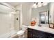 Clean bathroom featuring a glass-enclosed shower, toilet, and sink with modern fixtures at 17637 W 87Th Ave, Arvada, CO 80007