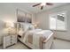 Comfortable bedroom with white wooden bed frame, neutral walls, and a ceiling fan at 17637 W 87Th Ave, Arvada, CO 80007