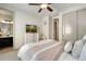 Bright bedroom features a TV, dresser, and closet for optimal storage and entertainment at 17637 W 87Th Ave, Arvada, CO 80007