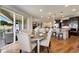 Elegant dining area with a table set for dinner, sliding glass doors, and an open concept design at 17637 W 87Th Ave, Arvada, CO 80007