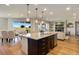 Open-concept kitchen features a large island with granite countertop and stainless steel appliances, connecting to dining and living areas at 17637 W 87Th Ave, Arvada, CO 80007
