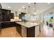 A chef's kitchen features a large island, granite counters, and modern stainless steel appliances at 17637 W 87Th Ave, Arvada, CO 80007