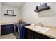 Well-equipped laundry room with modern appliances and ample counter space at 17637 W 87Th Ave, Arvada, CO 80007