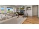 Living room with a fireplace, built-in shelves, plush sofa, and scenic outdoor view at 17637 W 87Th Ave, Arvada, CO 80007
