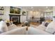 Open-concept living area with fireplace, comfortable seating, and staircase at 17637 W 87Th Ave, Arvada, CO 80007