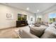 Relaxing living room area featuring a fireplace, tv, and large sectional sofa at 17637 W 87Th Ave, Arvada, CO 80007
