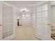 Basement view through french doors, featuring a fireplace and carpeted flooring at 937 S Cole Dr, Lakewood, CO 80228