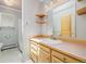 Cozy bathroom features wood cabinetry, and combination shower/tub at 937 S Cole Dr, Lakewood, CO 80228