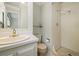 Classic bathroom with a neutral color scheme, featuring a vanity sink and a stand-up shower with updated fixtures at 937 S Cole Dr, Lakewood, CO 80228