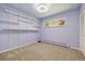 Bedroom showcasing a wall of shelving, a patterned ceiling, and neutral carpeting at 937 S Cole Dr, Lakewood, CO 80228