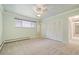 Bright bedroom featuring neutral walls, carpet, large closet and ceiling fan at 937 S Cole Dr, Lakewood, CO 80228