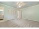 Carpeted bedroom features ceiling fan, closet, and ensuite bath entrance at 937 S Cole Dr, Lakewood, CO 80228
