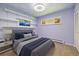 Stylish bedroom with a unique ceiling design, built-in shelves, and modern furnishings at 937 S Cole Dr, Lakewood, CO 80228