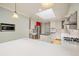 Spacious kitchen with skylight, white cabinetry, stainless steel appliances, and an island, ready for your culinary adventures at 937 S Cole Dr, Lakewood, CO 80228