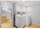 Bright laundry room with ample storage and white washer and dryer at 937 S Cole Dr, Lakewood, CO 80228