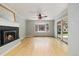 Spacious living room with fireplace, hardwood floors, and sliding glass door to yard at 937 S Cole Dr, Lakewood, CO 80228